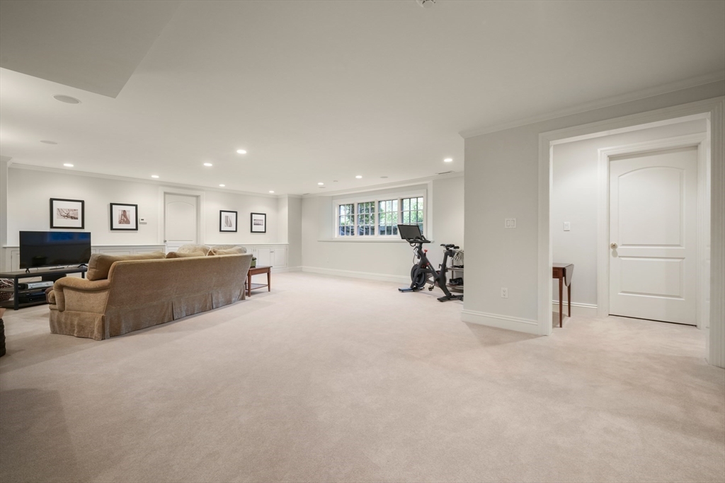1 Old Farm Road Wellesley, MA 02481 - Photo 36 of 41 a view of a livingroom with furniture and a flat screen tv