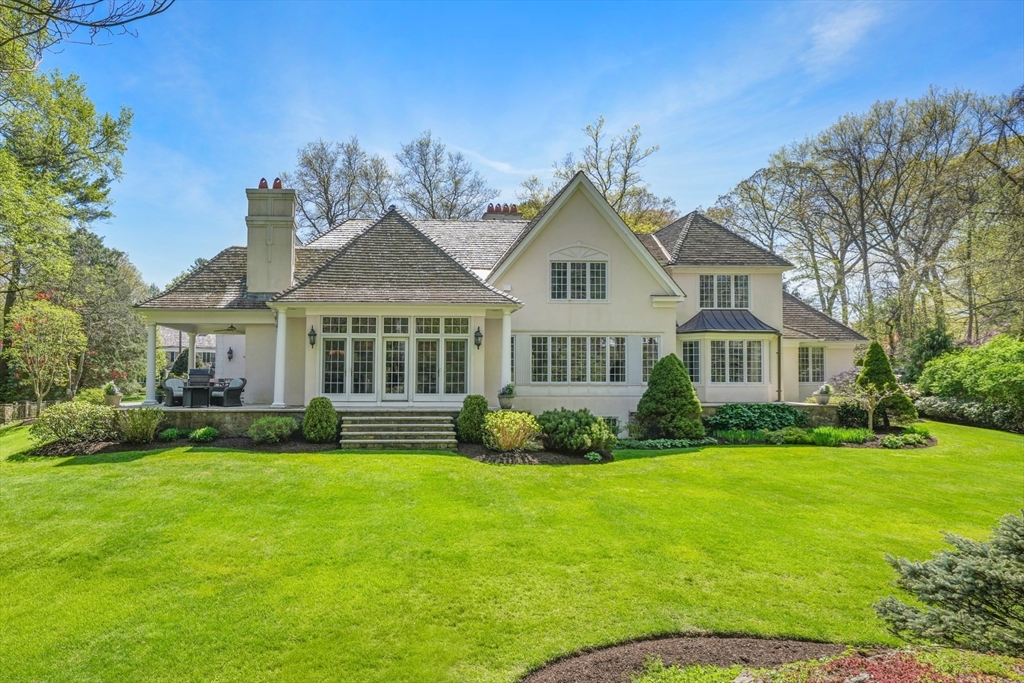 1 Old Farm Road Wellesley, MA 02481 - Photo 4 of 41 a front view of a house with a garden and porch