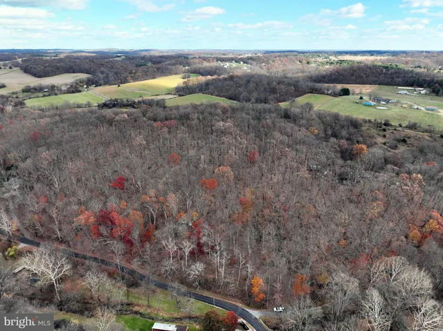 an aerial view of field with beach