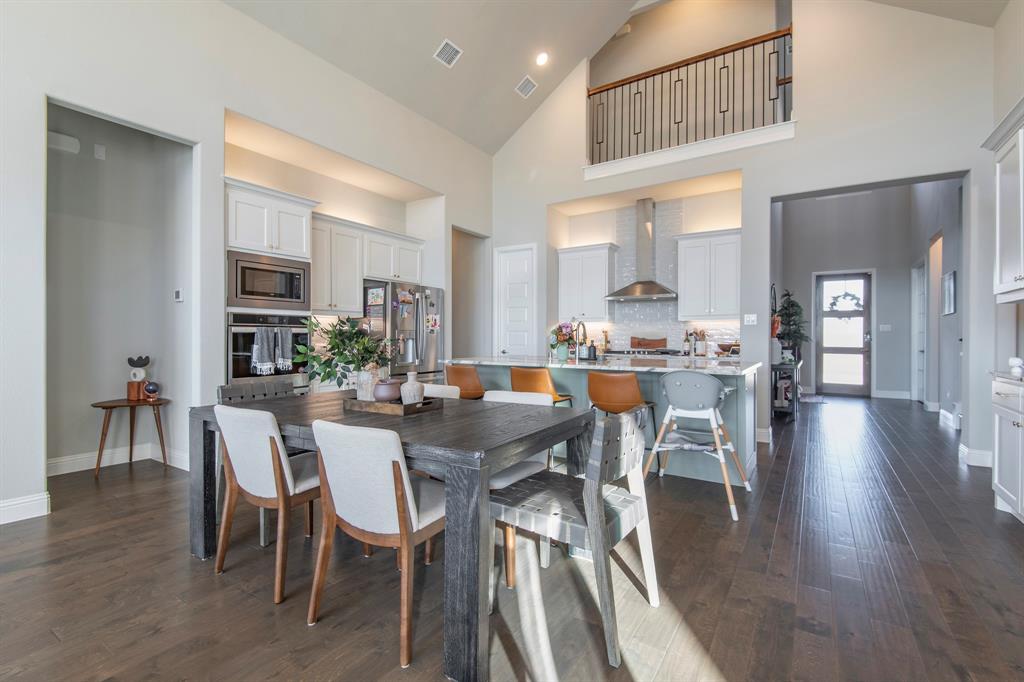 16650 Nightshade Road Frisco, TX 75033 - Photo 16 of 40 a view of a dining room with furniture and wooden floor