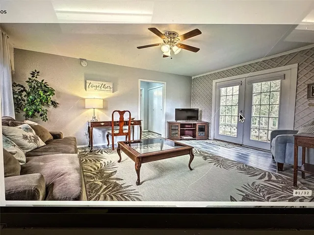 a living room with furniture and a flat screen tv