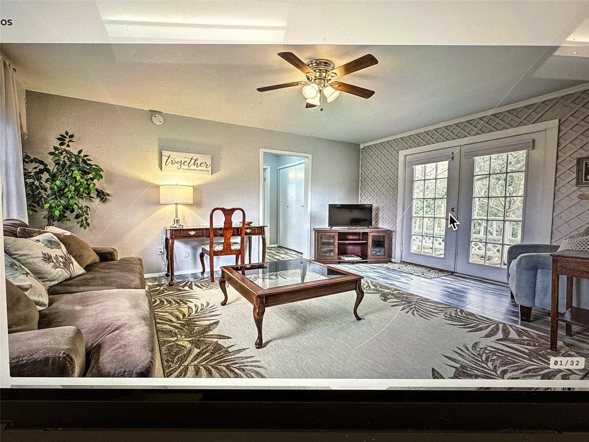 120 5th Street, Unit 14 Dickinson, TX 77539 - Photo 11 of 18 a living room with furniture and a flat screen tv