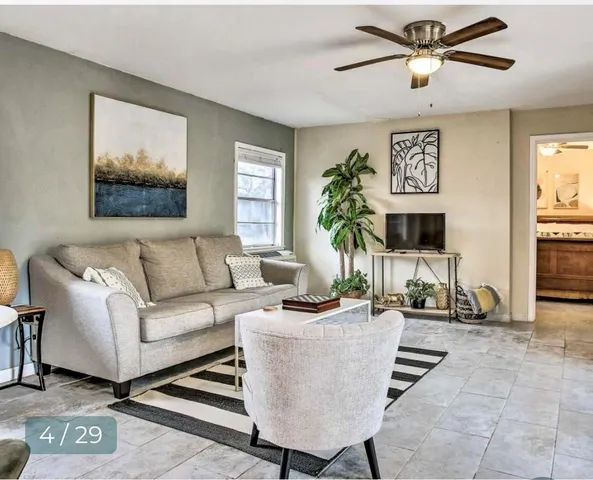 a living room with furniture and a flat screen tv