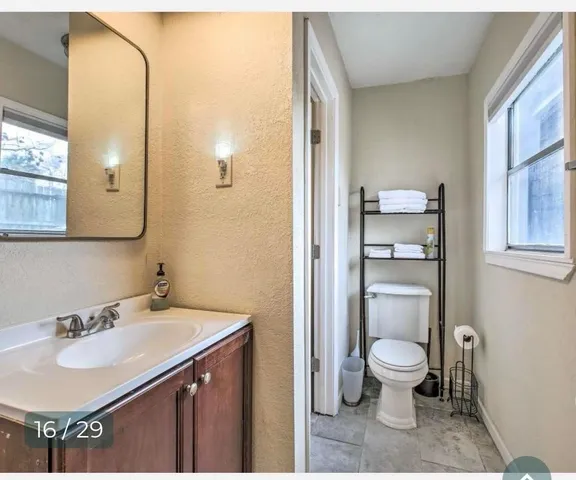 a bathroom with a sink toilet and a mirror