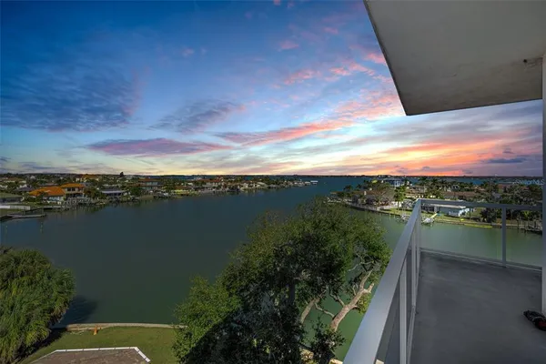 a terrace with outdoor seating and lake view