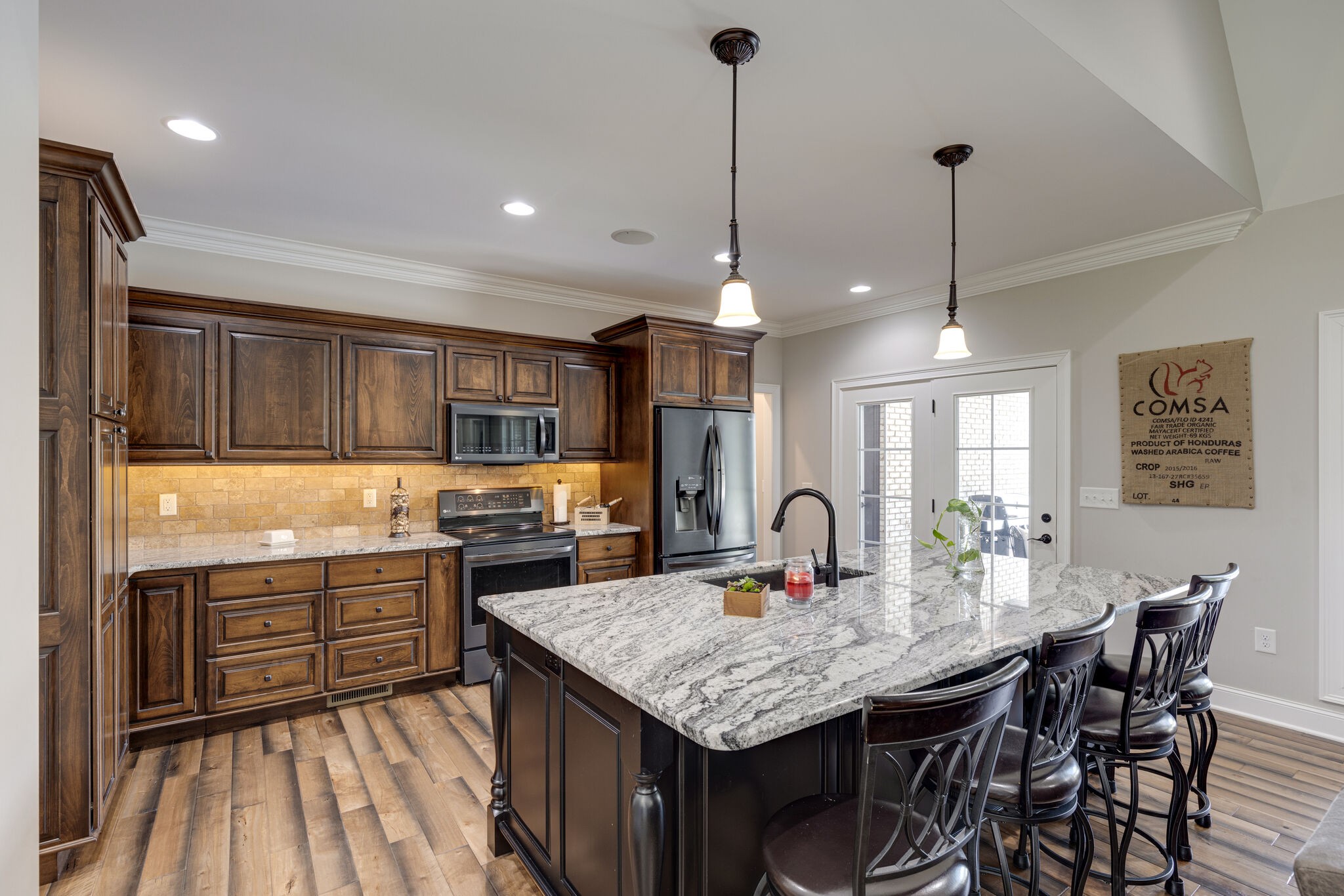 3165 Les Chappell Road Spring Hill, TN 37174 - Photo 11 of 70 a kitchen with stainless steel appliances granite countertop a sink a stove and a wooden floors