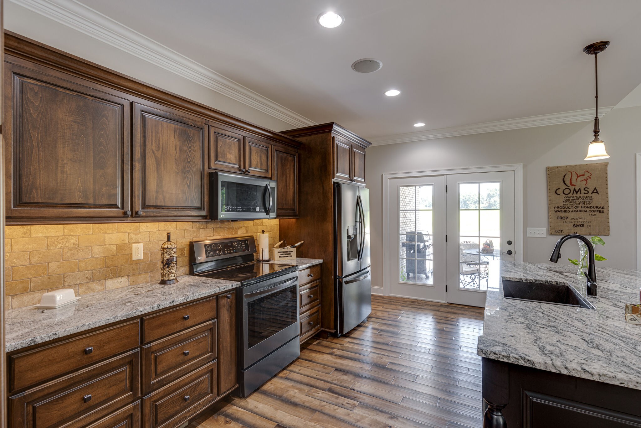 3165 Les Chappell Road Spring Hill, TN 37174 - Photo 13 of 70 a kitchen with granite countertop a stove and cabinets