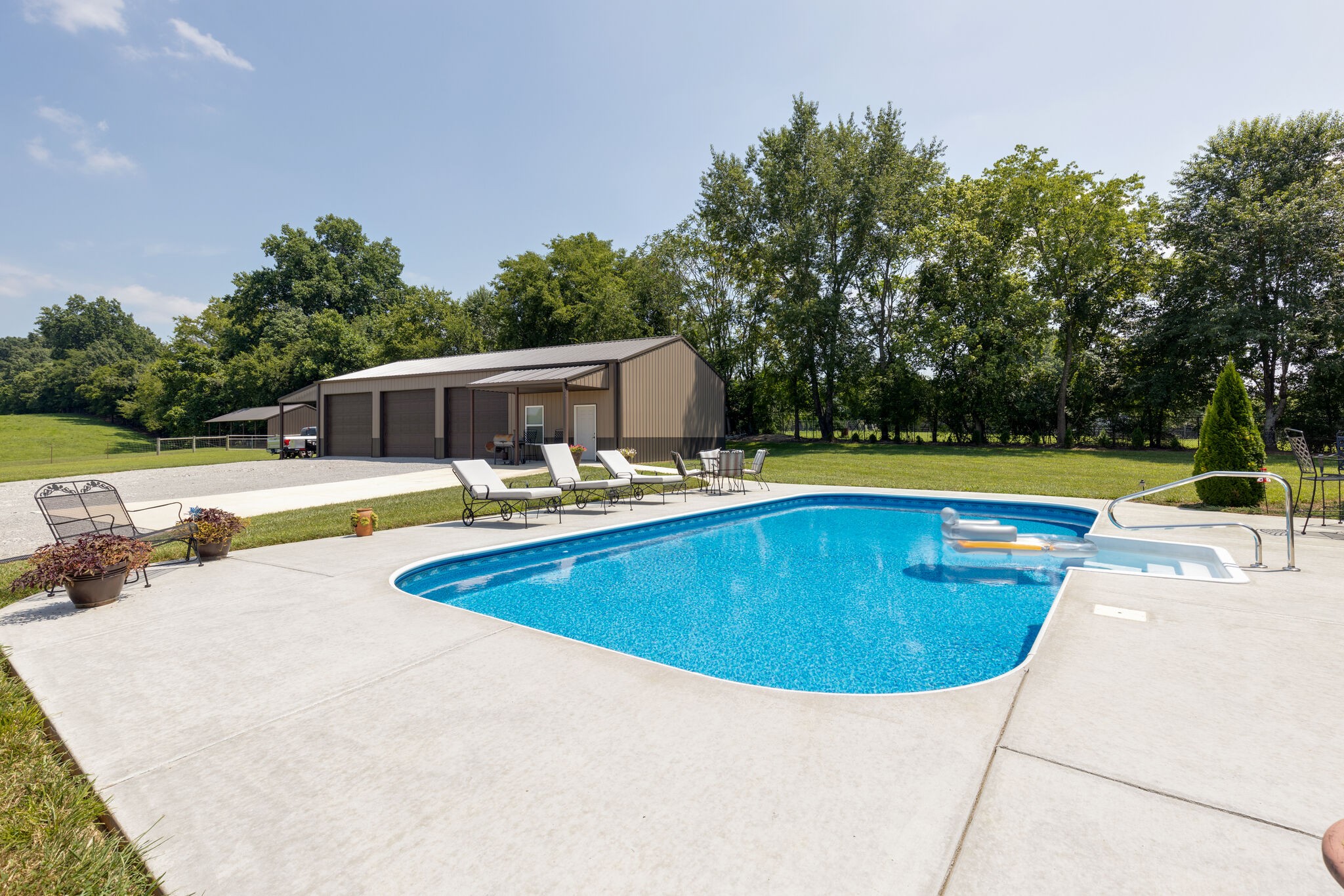 3165 Les Chappell Road Spring Hill, TN 37174 - Photo 52 of 70 swimming pool view with a seating space and a garden view