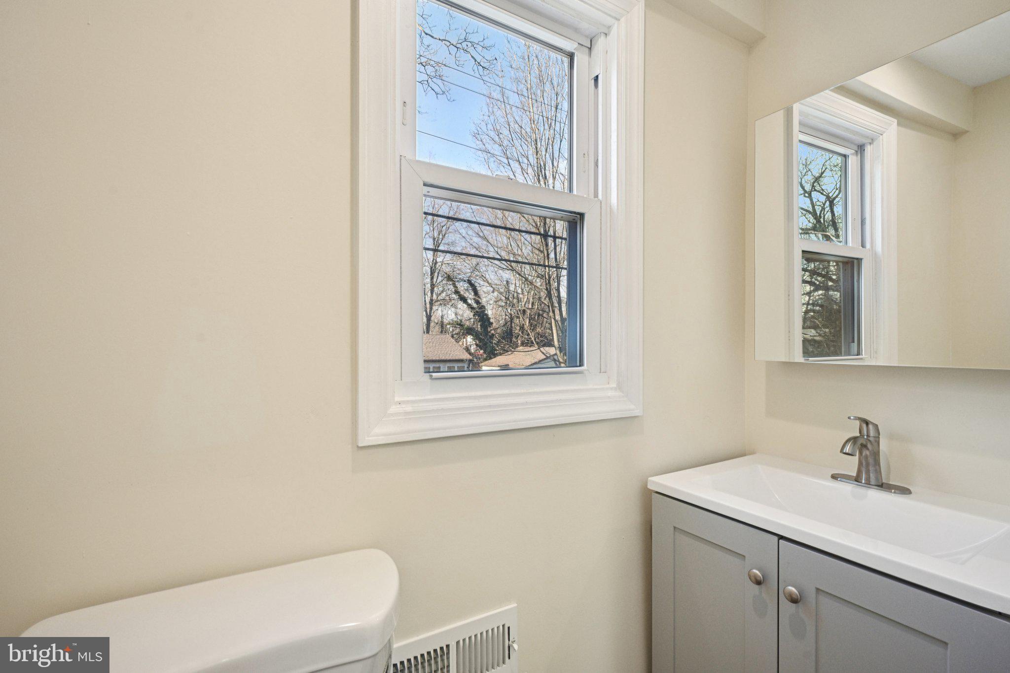 195 Chews Landing Road Clementon, NJ 08021 - Photo 24 of 48 a bathroom with a toilet a sink and a window
