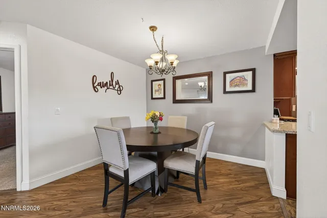 a view of a dining room with furniture wooden floor and a chandelier
