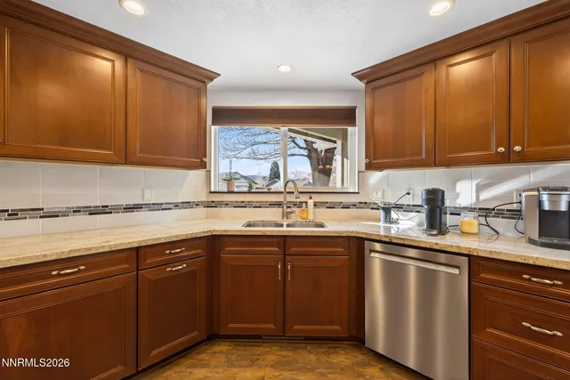 a kitchen with stainless steel appliances granite countertop a sink stove and cabinets