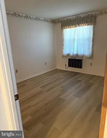 a view of room with window and hardwood