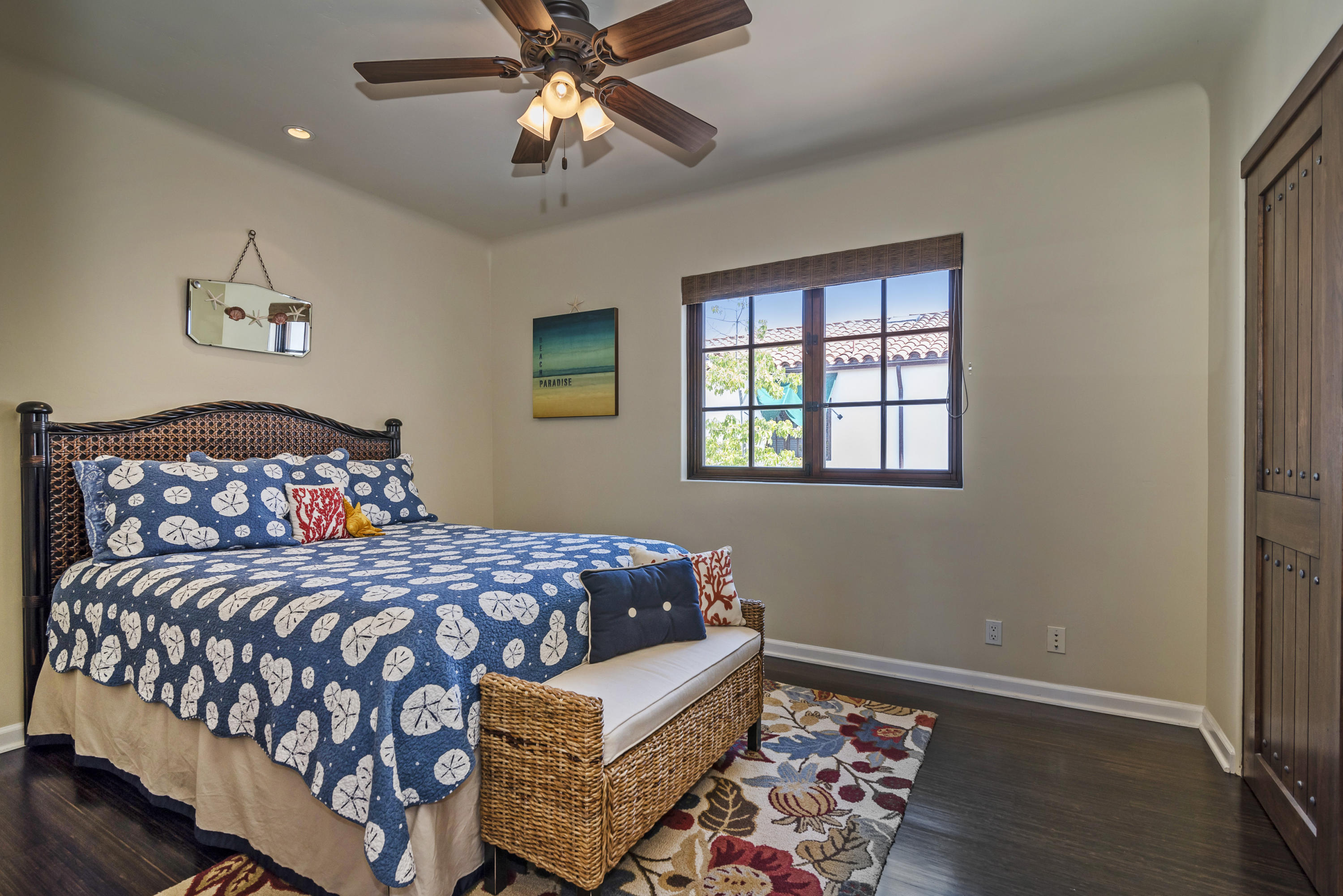 4004 Via Lucero, Unit 7 Santa Barbara, CA 93110 - Photo 8 of 14 a bedroom with a bed and a chandelier