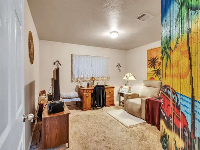 a bed room with furniture and a flat screen tv