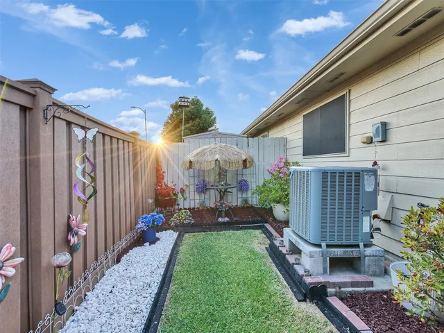 a view of a house with backyard and sitting area