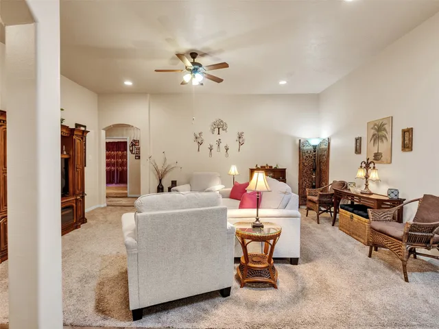 a living room with furniture and a chandelier