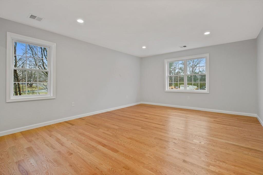 6 Sheffield Road Framingham, MA 01701 - Photo 20 of 32 a view of an empty room with wooden floor and a window