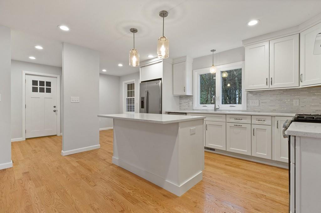 6 Sheffield Road Framingham, MA 01701 - Photo 4 of 32 a large kitchen with cabinets and wooden floor