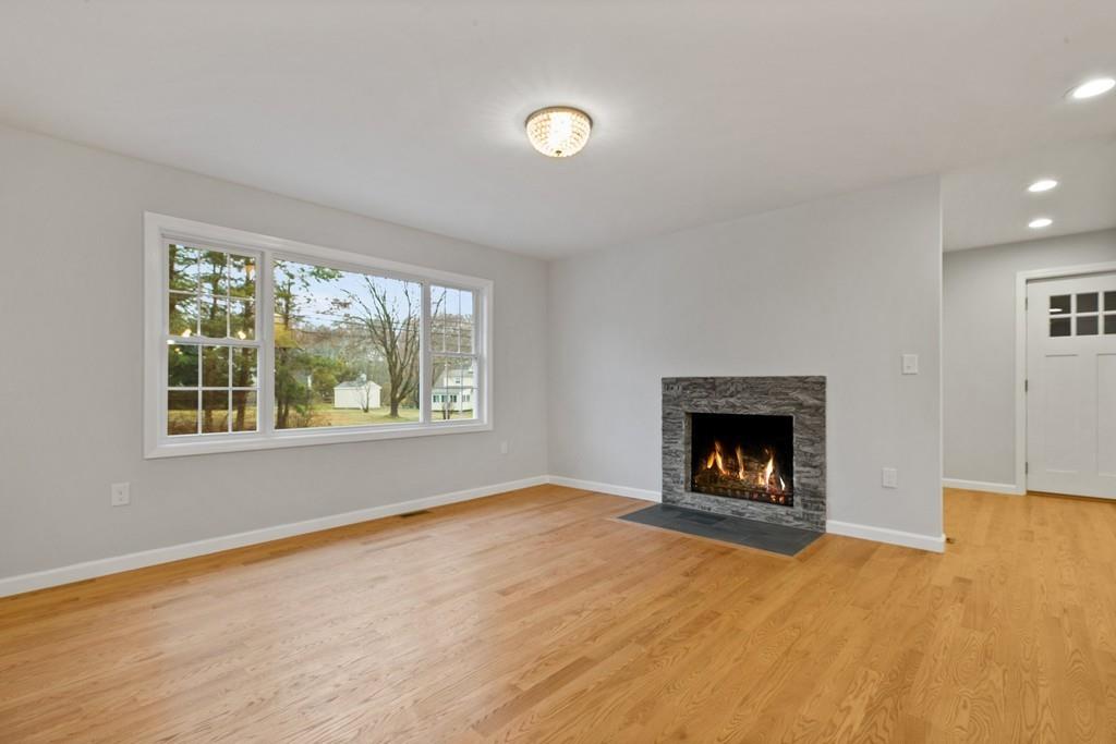 6 Sheffield Road Framingham, MA 01701 - Photo 10 of 32 an empty room with windows and fireplace
