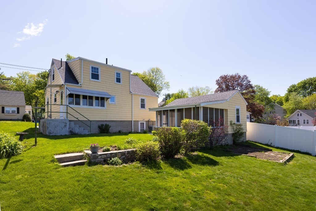 24 Endicott Road Stoneham, MA 02180 - Photo 11 of 15 a front view of a house with a garden and plants