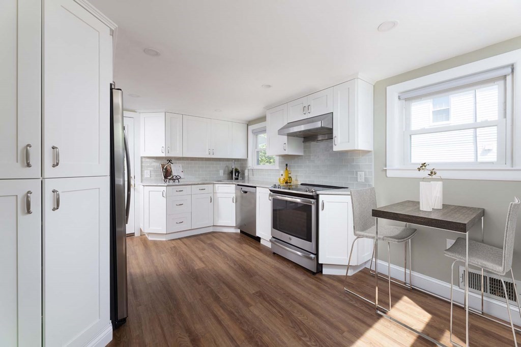 24 Endicott Road Stoneham, MA 02180 - Photo 3 of 15 a kitchen with granite countertop a sink cabinets and stainless steel appliances