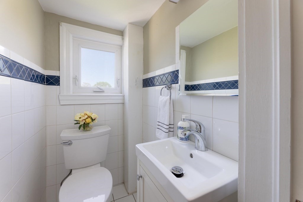 24 Endicott Road Stoneham, MA 02180 - Photo 8 of 15 a bathroom with a sink mirror and toilet