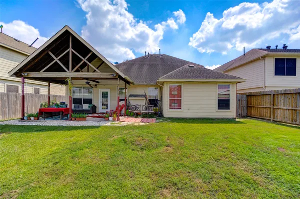 a view of a house with a yard patio and fire pit