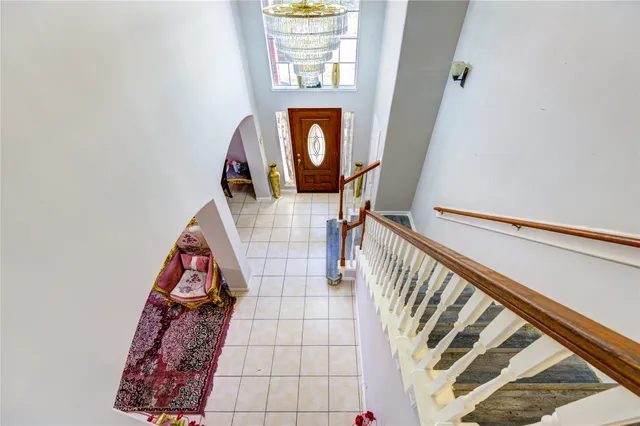 a view of stairs with furniture and wooden floor