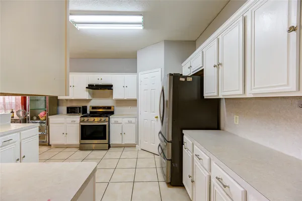 a kitchen with a refrigerator stove and microwave
