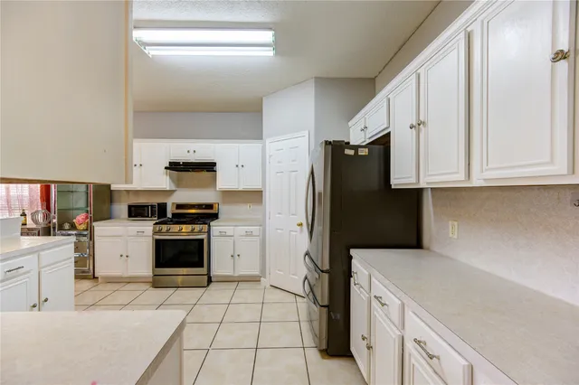 a kitchen with a refrigerator stove and microwave