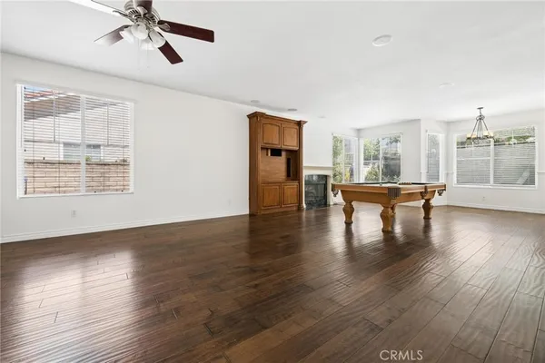 a kitchen with stainless steel appliances refrigerator and wooden floor