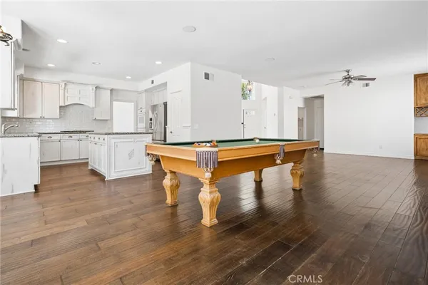 a living room with fireplace furniture and a wooden floor