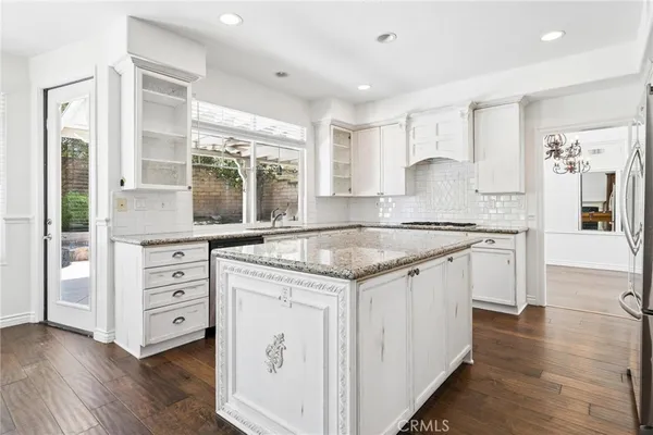 a large kitchen with stainless steel appliances granite countertop a sink stove and refrigerator