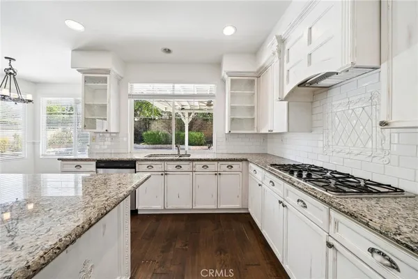 a kitchen with a sink stove and refrigerator