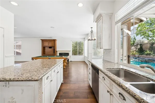 a kitchen with stainless steel appliances granite countertop a stove and a sink