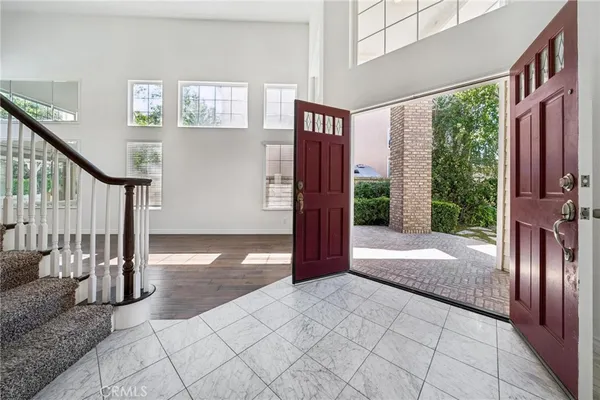 a view of entryway and hall with wooden floor
