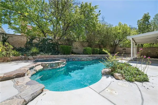 a view of backyard with deck and garden