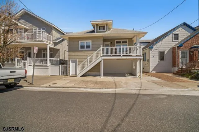 a front view of a house with a road