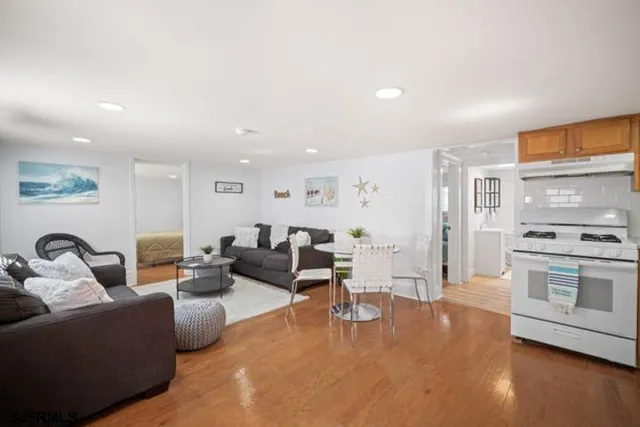 a living room with furniture wooden floor and a fireplace