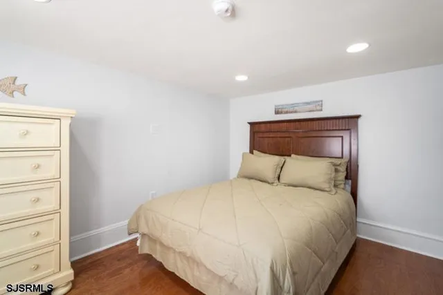 a bedroom with a bed and a dresser