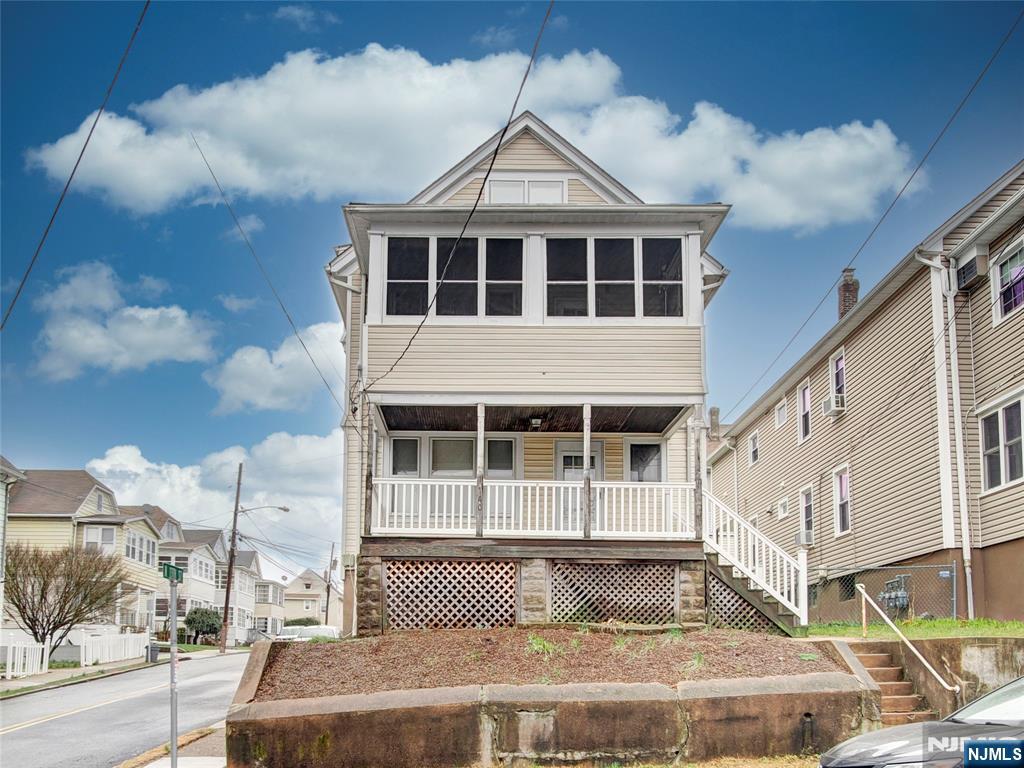 140 Westervelt Avenue Hawthorne, NJ 07506 - Photo 1 of 36 a front view of a house with a yard