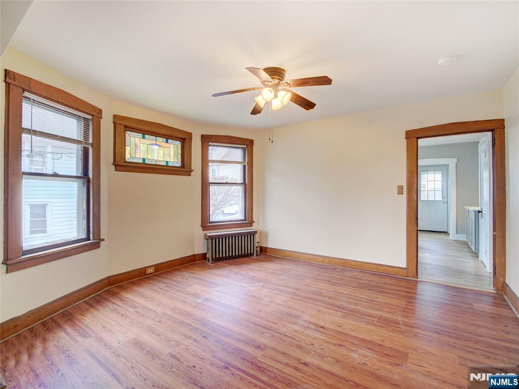 140 Westervelt Avenue Hawthorne, NJ 07506 - Photo 13 of 36 a view of an empty room with a window and wooden floor