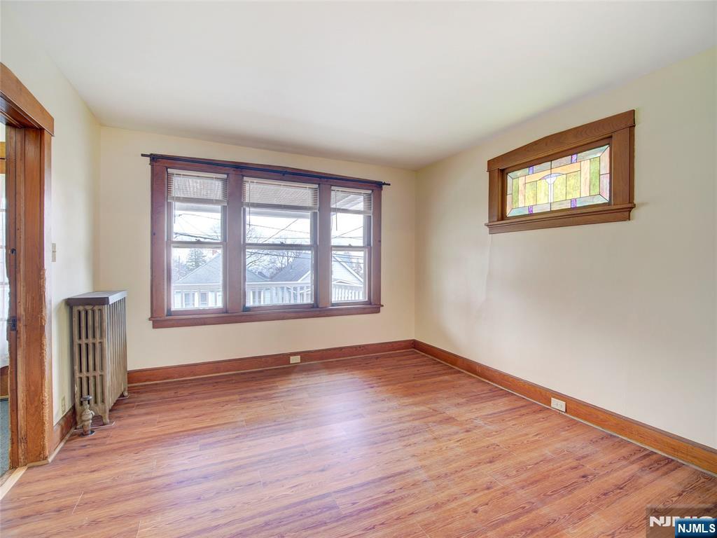 140 Westervelt Avenue Hawthorne, NJ 07506 - Photo 15 of 36 a view of an empty room with wooden floor and a window