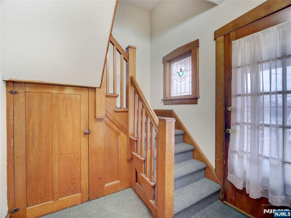 140 Westervelt Avenue Hawthorne, NJ 07506 - Photo 17 of 36 a view of staircase with lots of frames on wall and wooden floor
