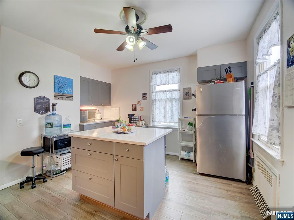 140 Westervelt Avenue Hawthorne, NJ 07506 - Photo 21 of 36 a kitchen with a refrigerator a sink dishwasher a dining table and chairs