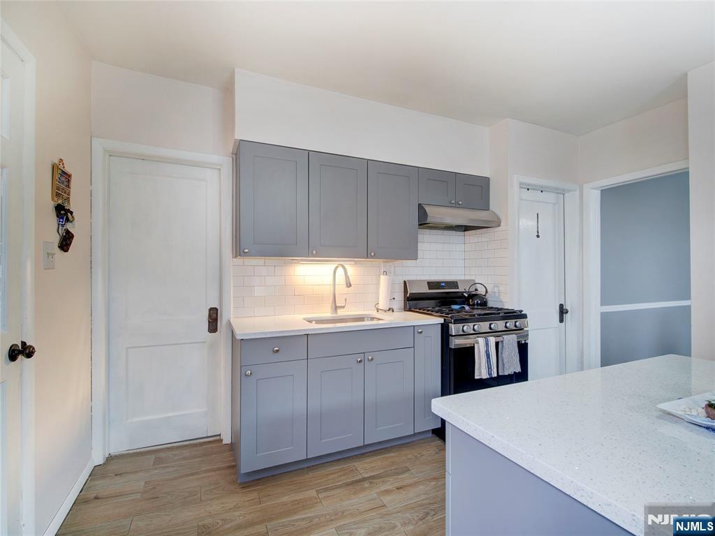 140 Westervelt Avenue Hawthorne, NJ 07506 - Photo 22 of 36 a kitchen with a stove a sink and a refrigerator