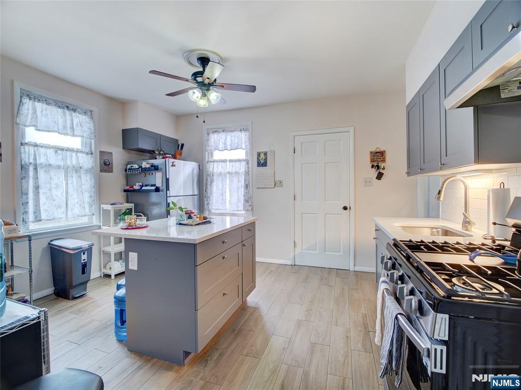 140 Westervelt Avenue Hawthorne, NJ 07506 - Photo 23 of 36 a kitchen with stainless steel appliances a stove a sink and a refrigerator