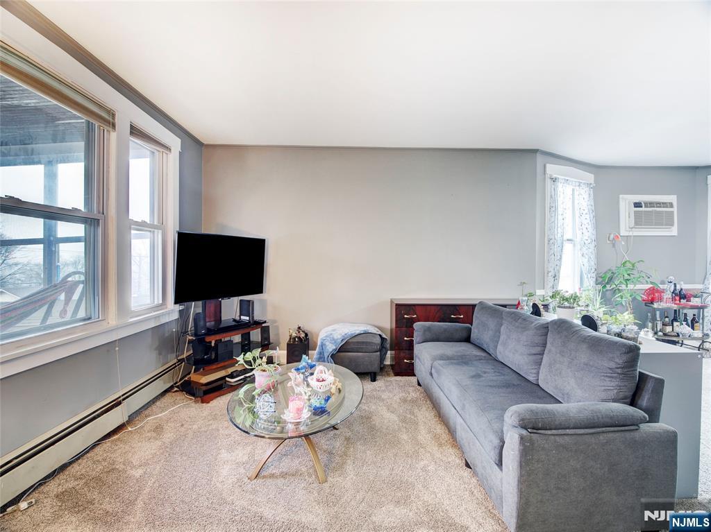 140 Westervelt Avenue Hawthorne, NJ 07506 - Photo 26 of 36 a living room with furniture and a flat screen tv