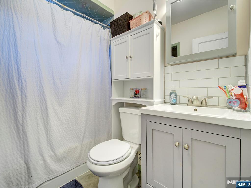 140 Westervelt Avenue Hawthorne, NJ 07506 - Photo 27 of 36 a bathroom with a sink toilet and vanity
