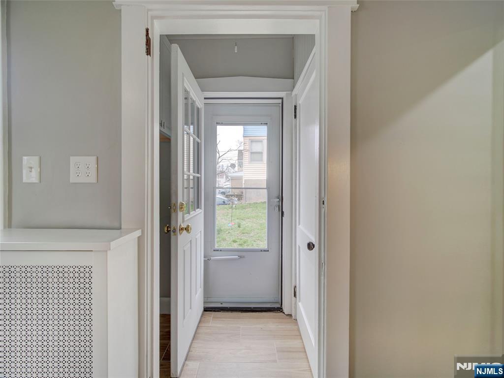 140 Westervelt Avenue Hawthorne, NJ 07506 - Photo 4 of 36 a view of a hallway with a wooden door